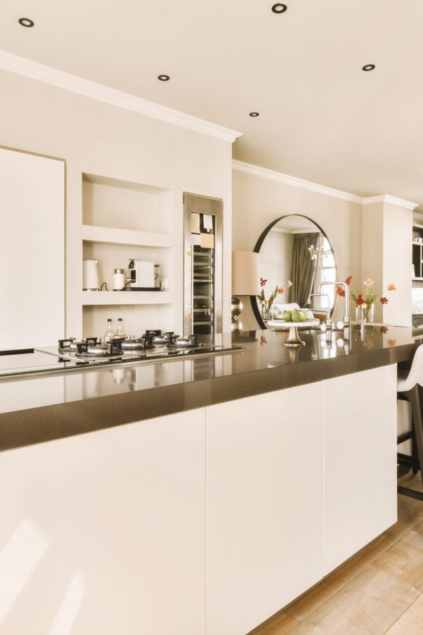 a modern kitchen with white cabinets and black counter tops on the island in this room is very spacious, but it's not