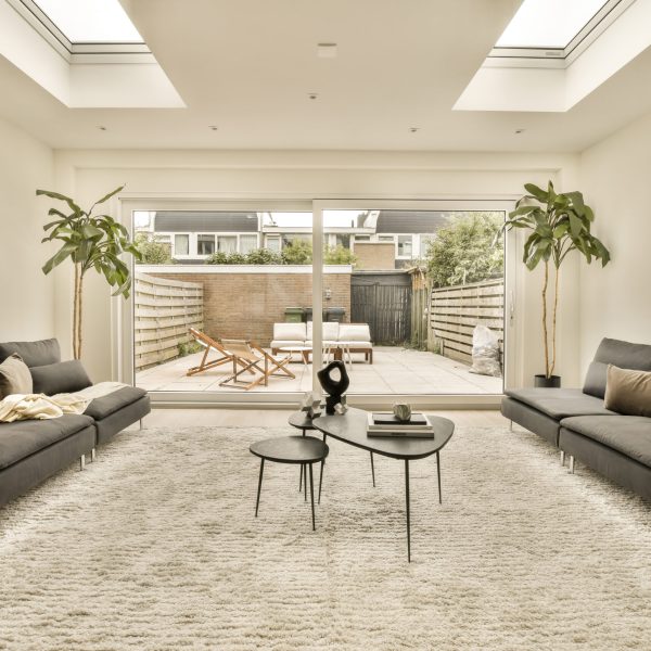 a living room with two couches, a coffee table and a television set in the middle of the room