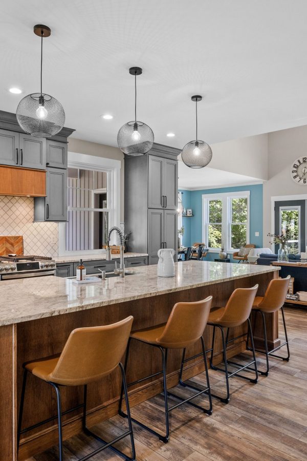 The interior design of a beautiful kitchen with a large island in a modern new England colonial home